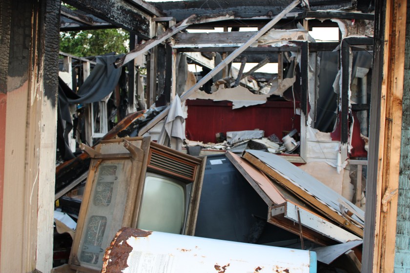 A photo showing a room damaged by fire.