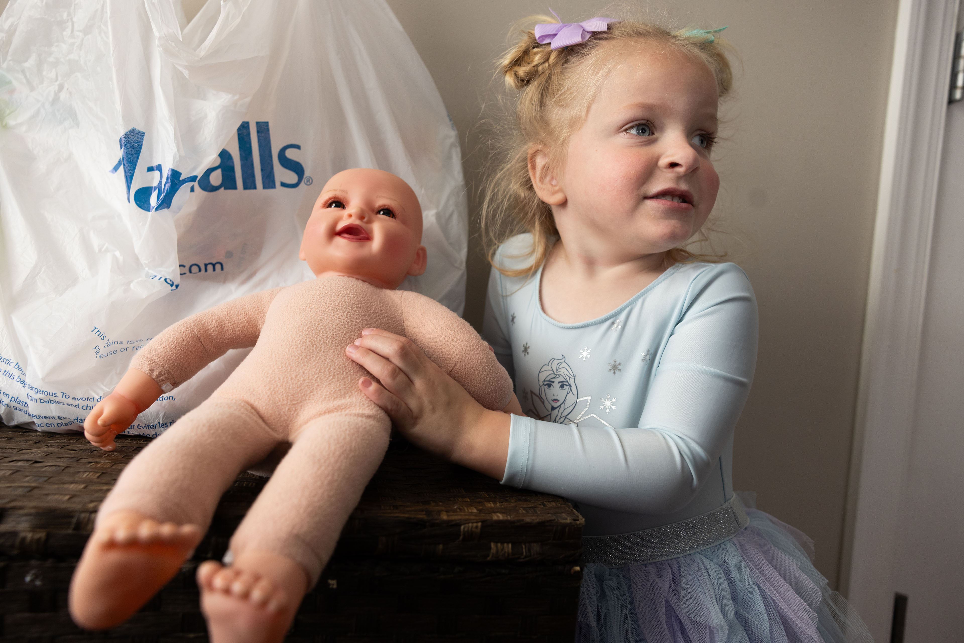 autism-medicaid_osborne_01 A 3-year-old girl holds a baby doll.