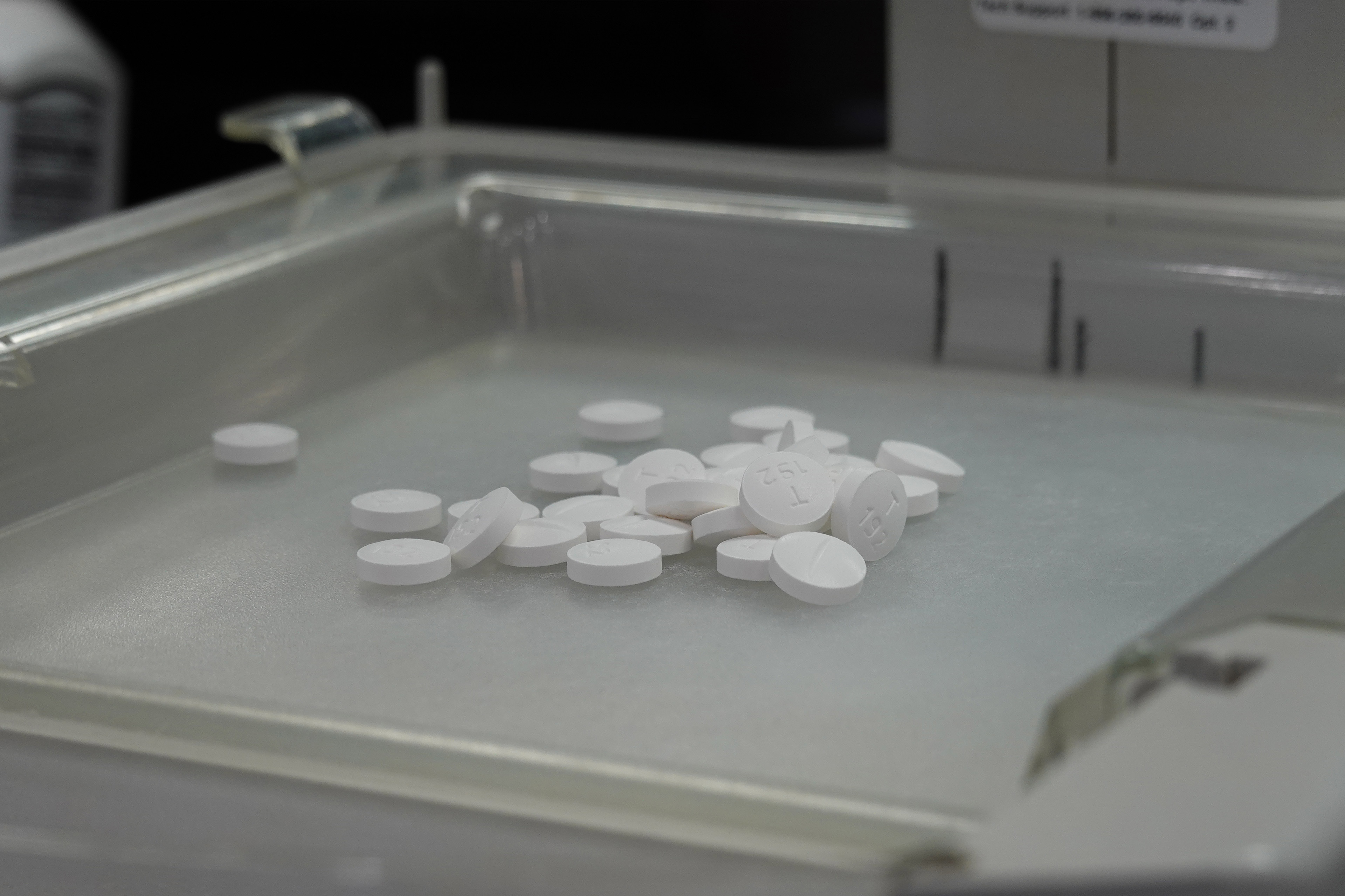A photo of white, circular pills on a tray.