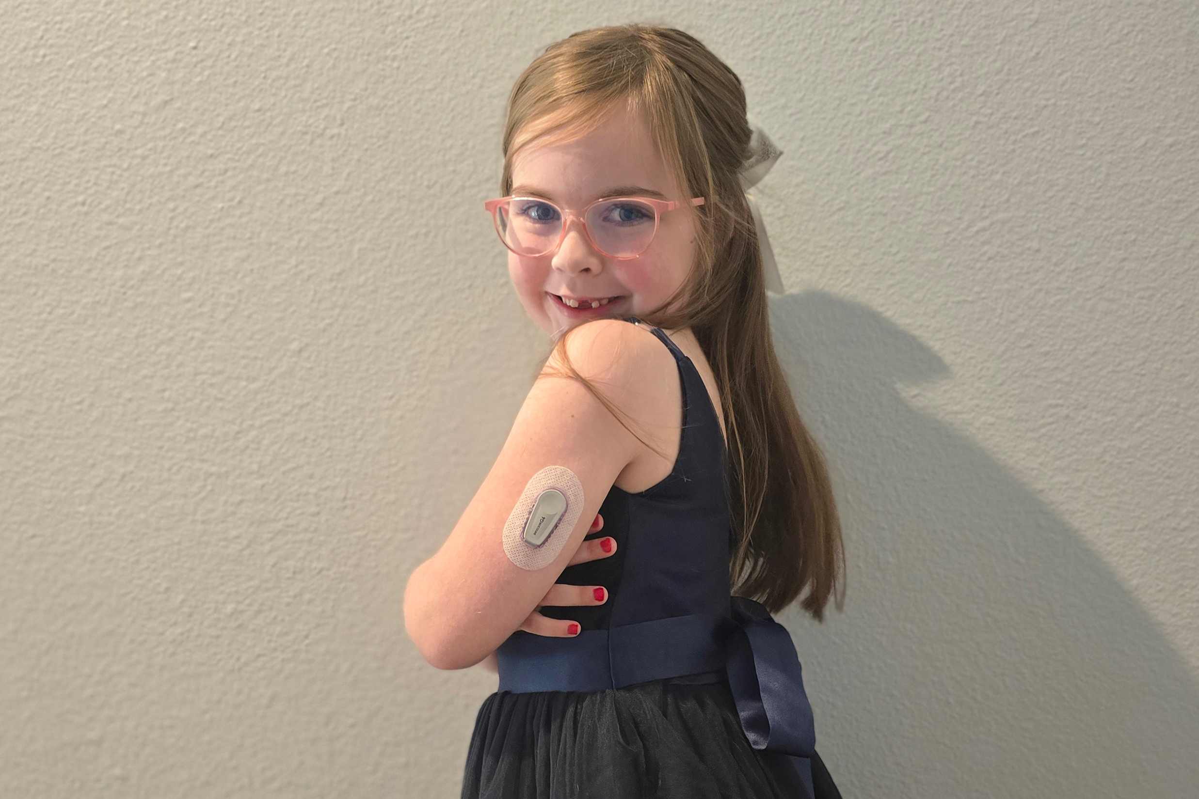 diabetesdeductible_01 A 6-year-old girl poses for a portrait showing her glucose monitor on her arm.