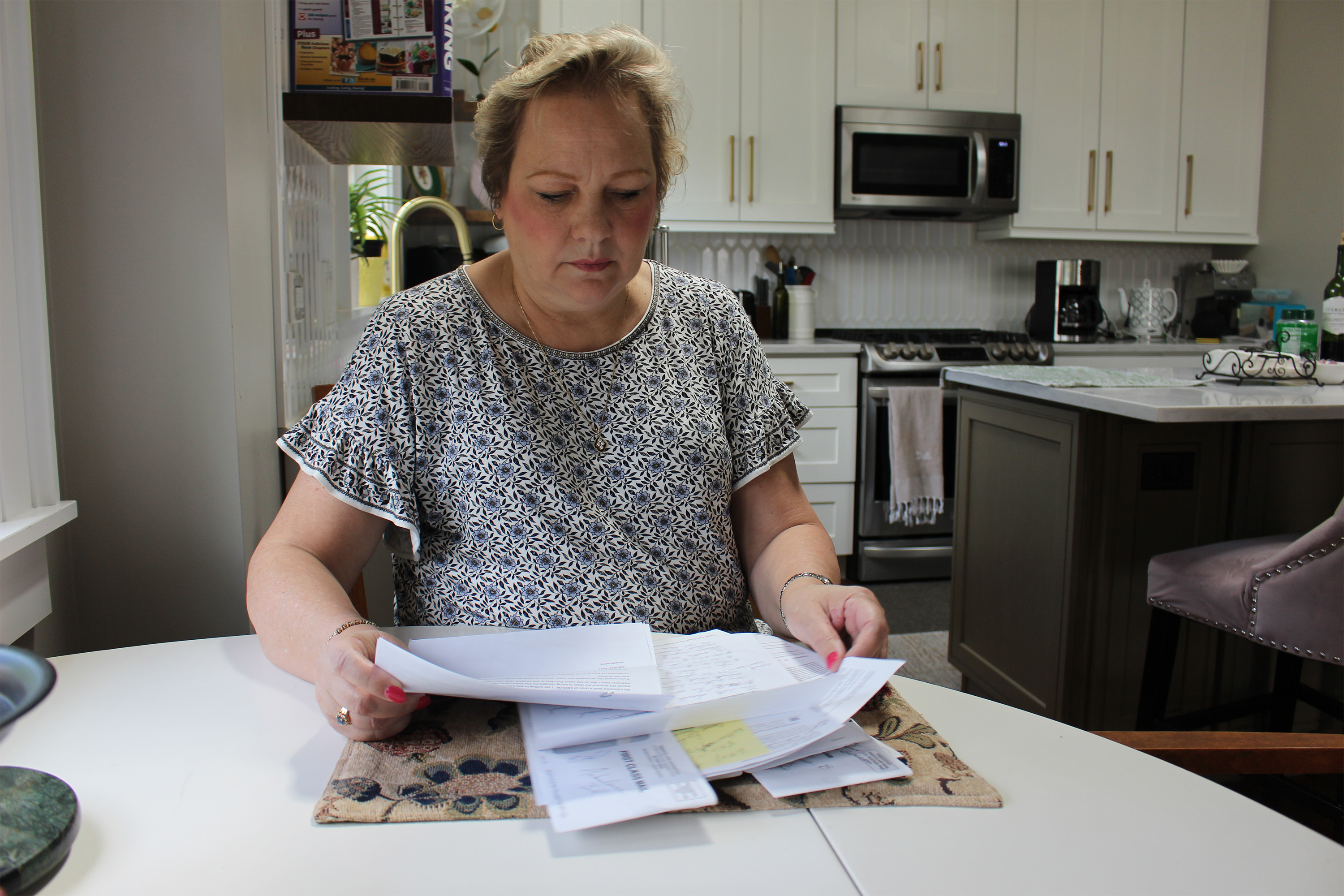 dula_01-resized A photo of Peggy Dula reading medical bills.
