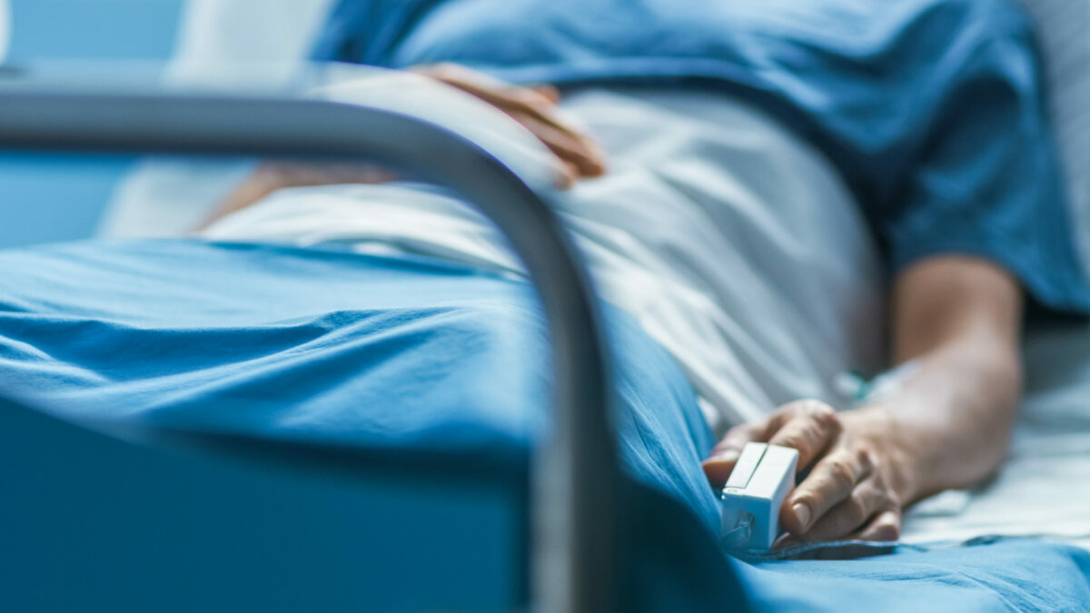 A patient lying in a hospital bed.