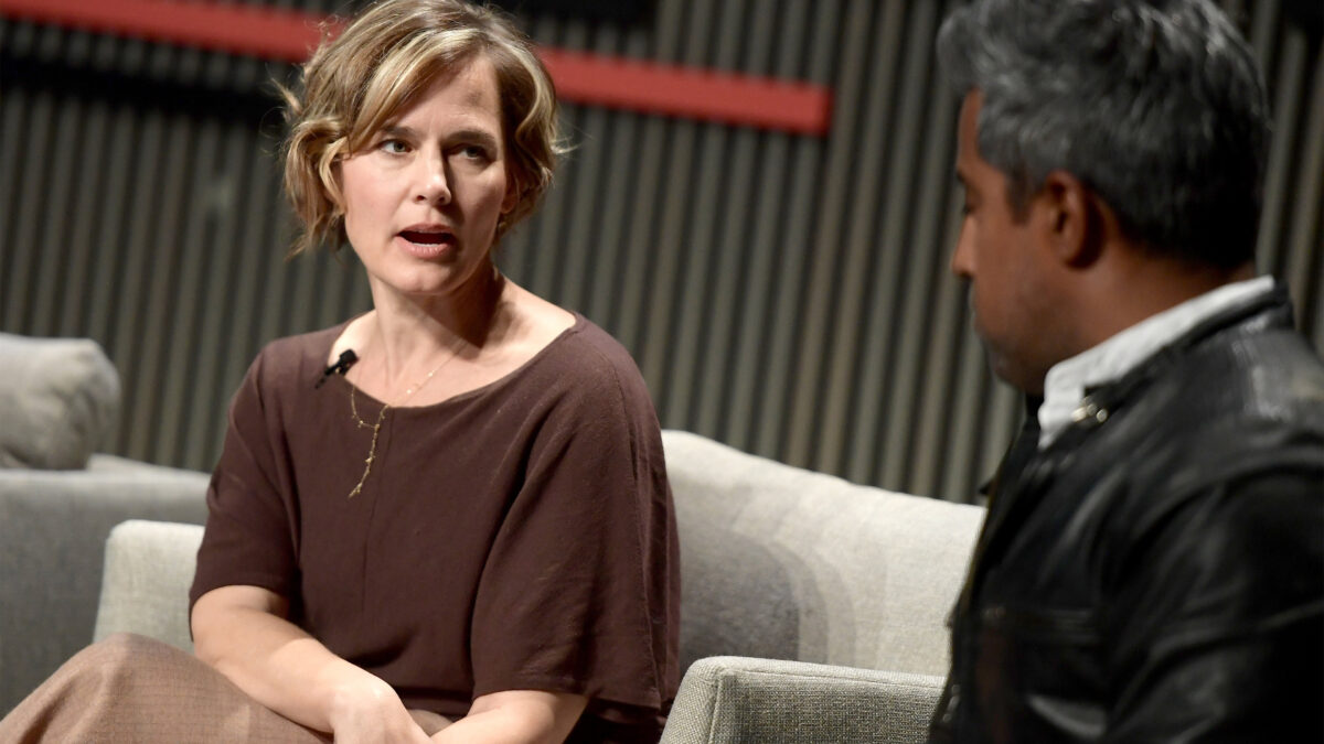 A photo of Jennifer Pahlka speaking to Anand Giridharadas onstage at a conference.