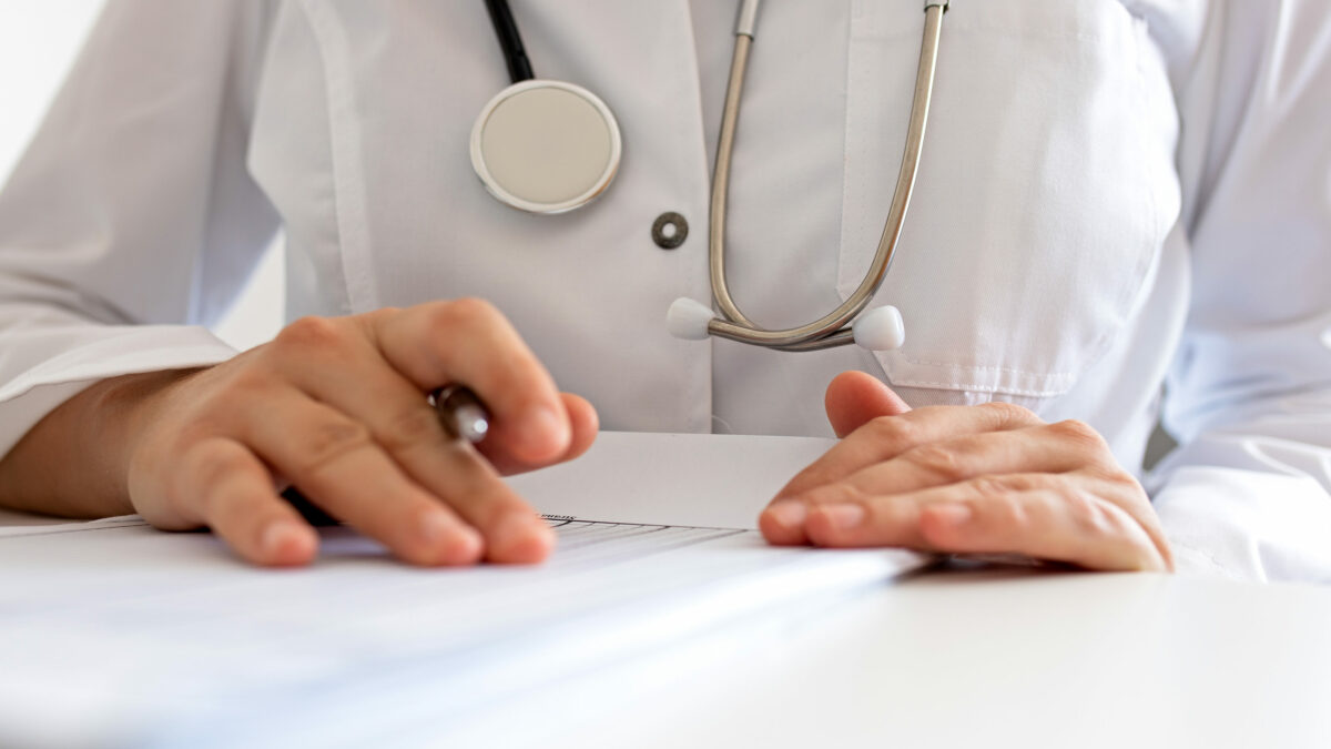A photo of a doctor filling out a form.