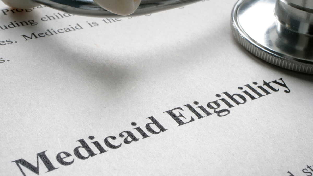 A photo of a piece of paper that reads, "Medicaid Eligibility" with a stethoscope on top.