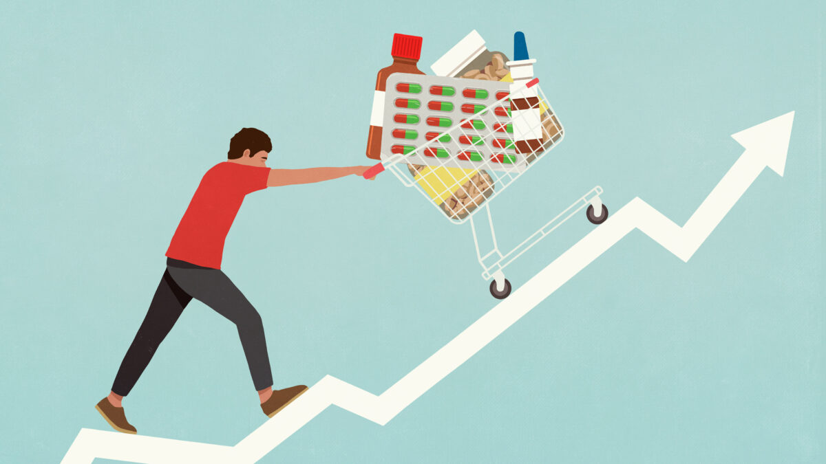 An illustration of a man pushing a grocery cart full of medical supplies up a hill that looks like a stock arrow pointing upward.