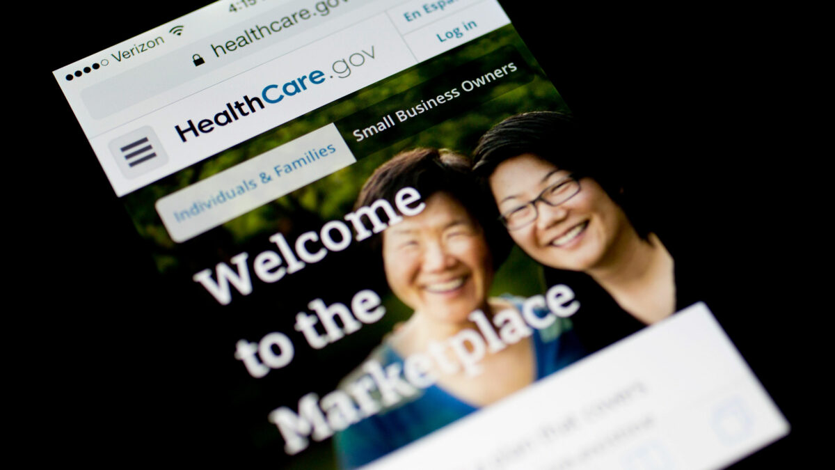 A photo of a phone screen showing the HealthCare.gov website.