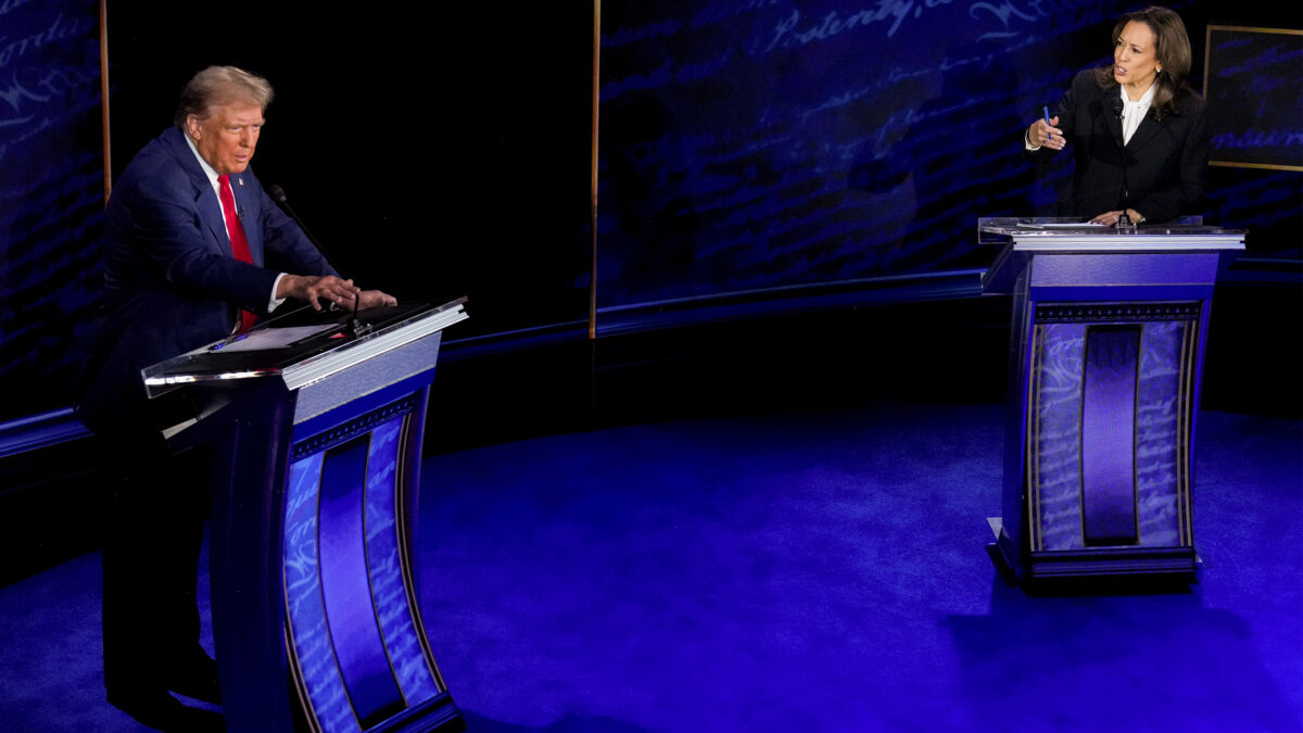 A photo of Kamala Harris and Donald Trump speaking from behind podiums on the debate stage.
