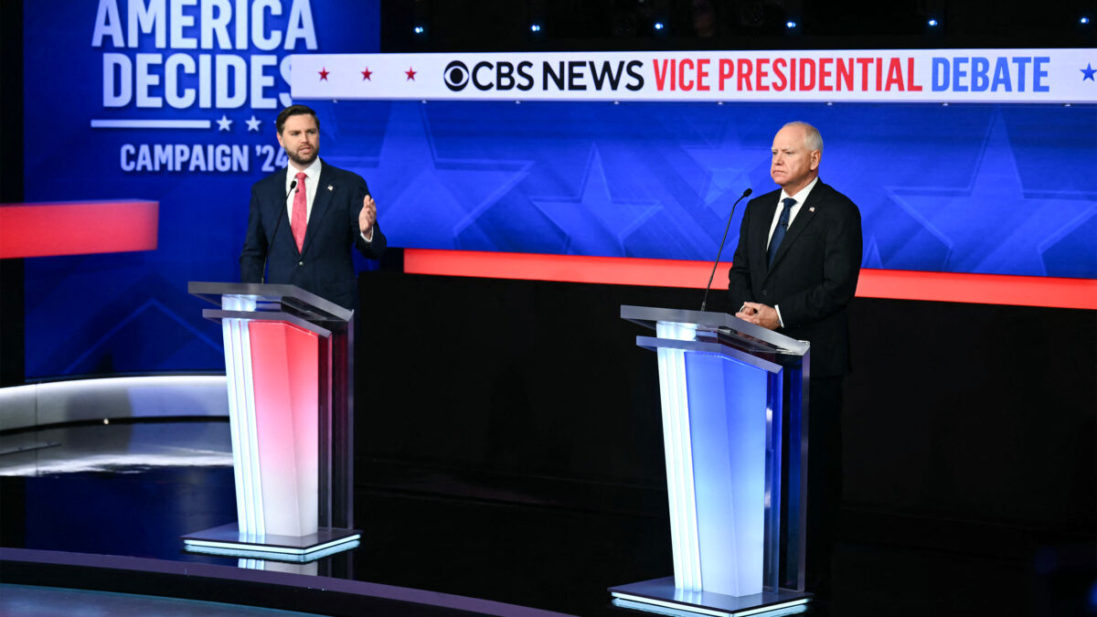 A photo of JD Vance and Tim Walz standing at podiums in a TV studio.