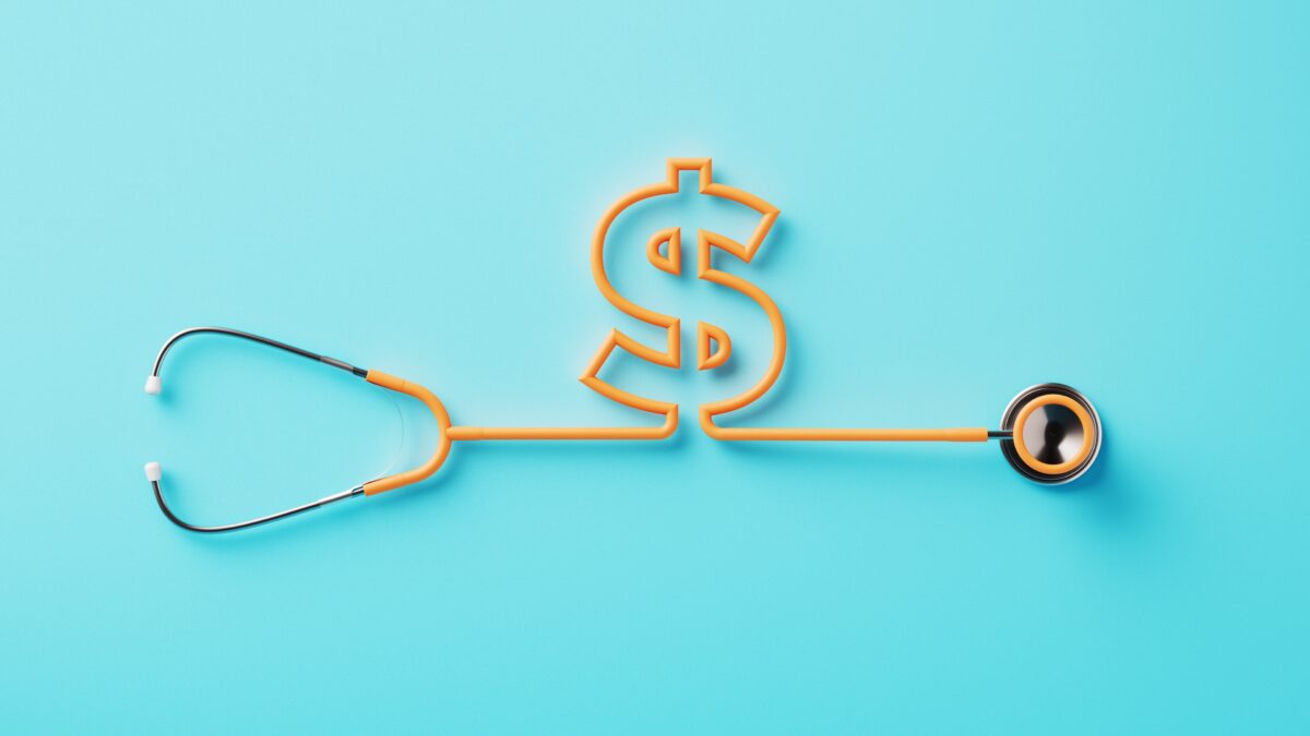 Orange stethoscope forming a dollar sign on blue background.