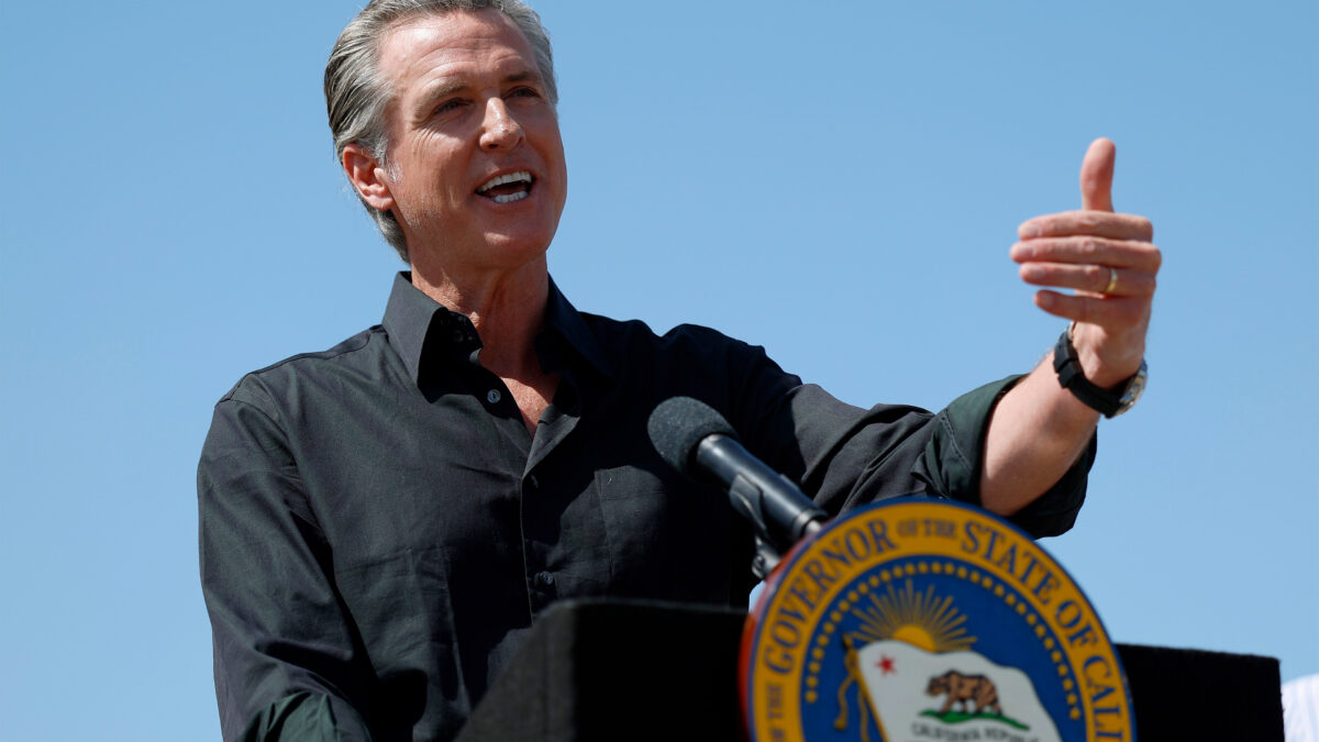 A photo of Governor Gavin Newsom speaking at a podium with the governor's seal on it.