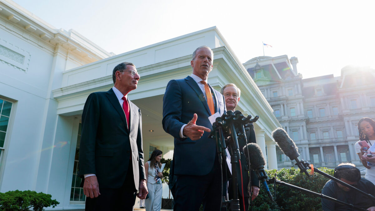A photo of three US senators standing for a news huddle outside of the White House.