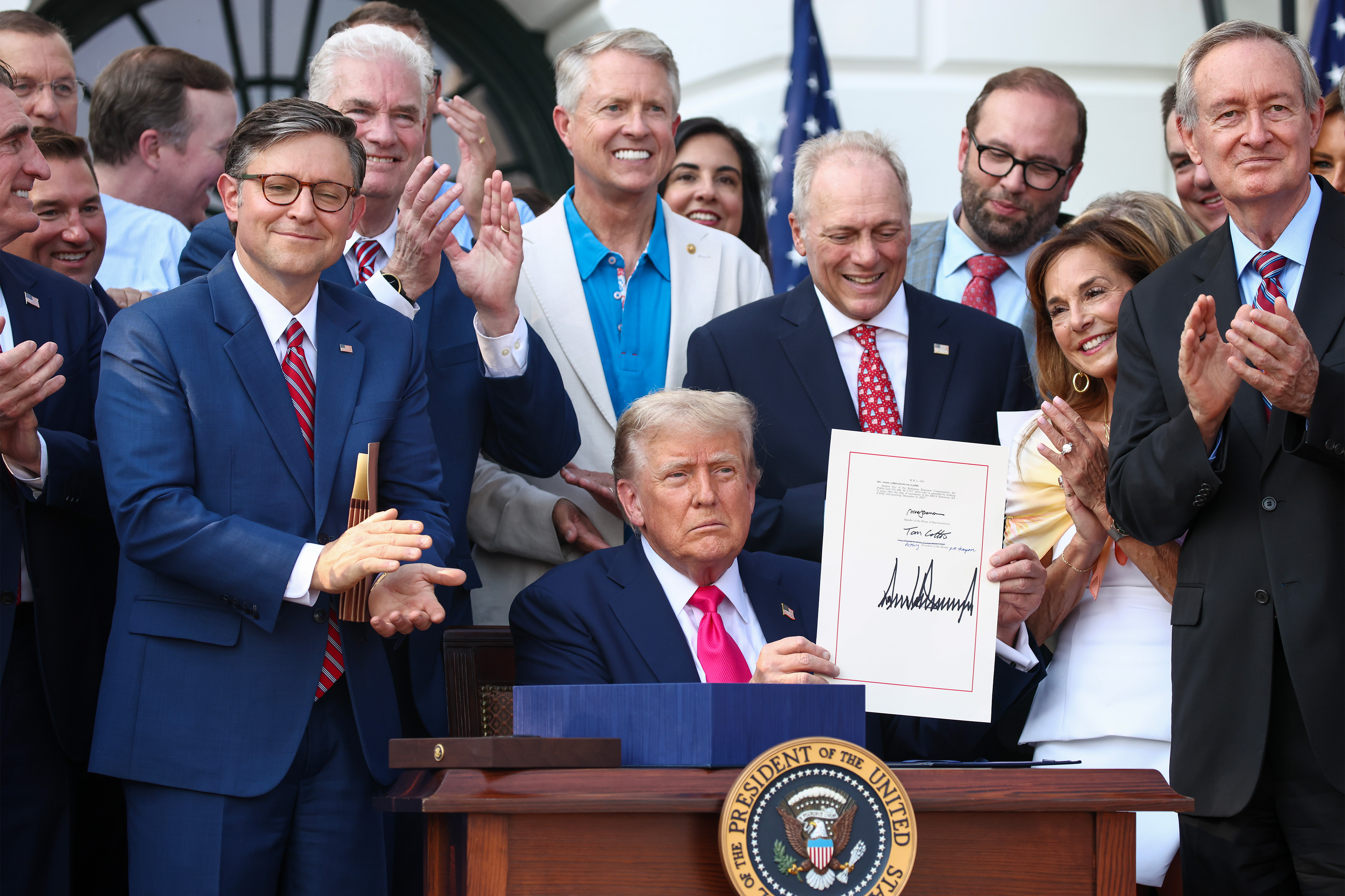 gettyimages-2223602542-resized A photo of President Trump holding up his signed portion of the One Big Beautiful Bill Act. Surrounding him are Republican senators and representatives.