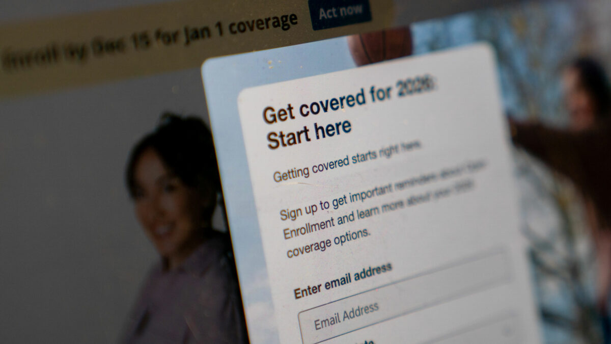 A photo of HealthCare.gov's website. A pop-up form reads, "Get covered for 2026. Start here."