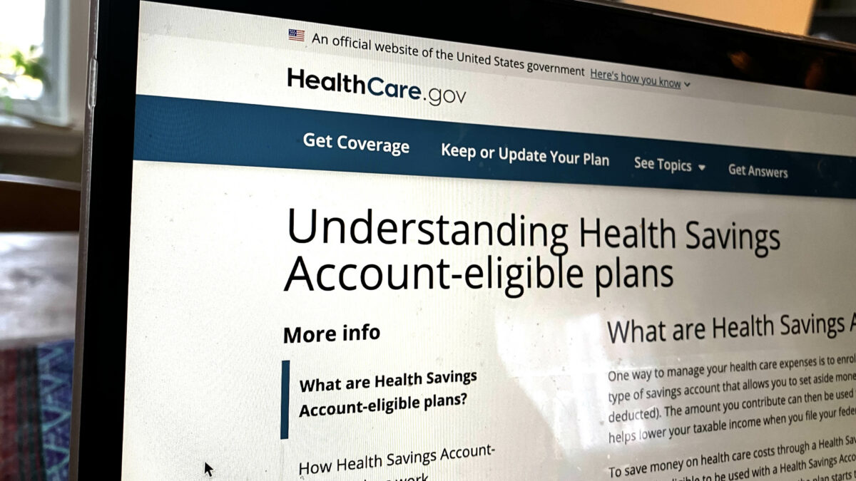 A photo of the healthcare.gov website on a laptop, which shows a page with information about HSAs.