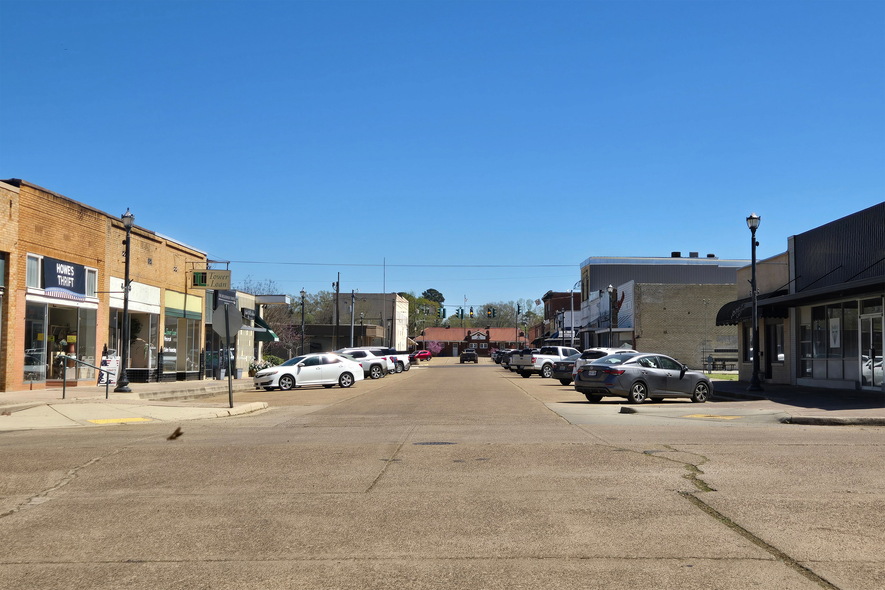 louisiana-resized A photo of a street in Vivian, Louisiana. Cars are pulled into parking spots and small shops line the street.
