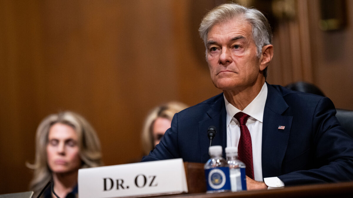 A photo showing Mehmet Oz sitting at a table in a court room.