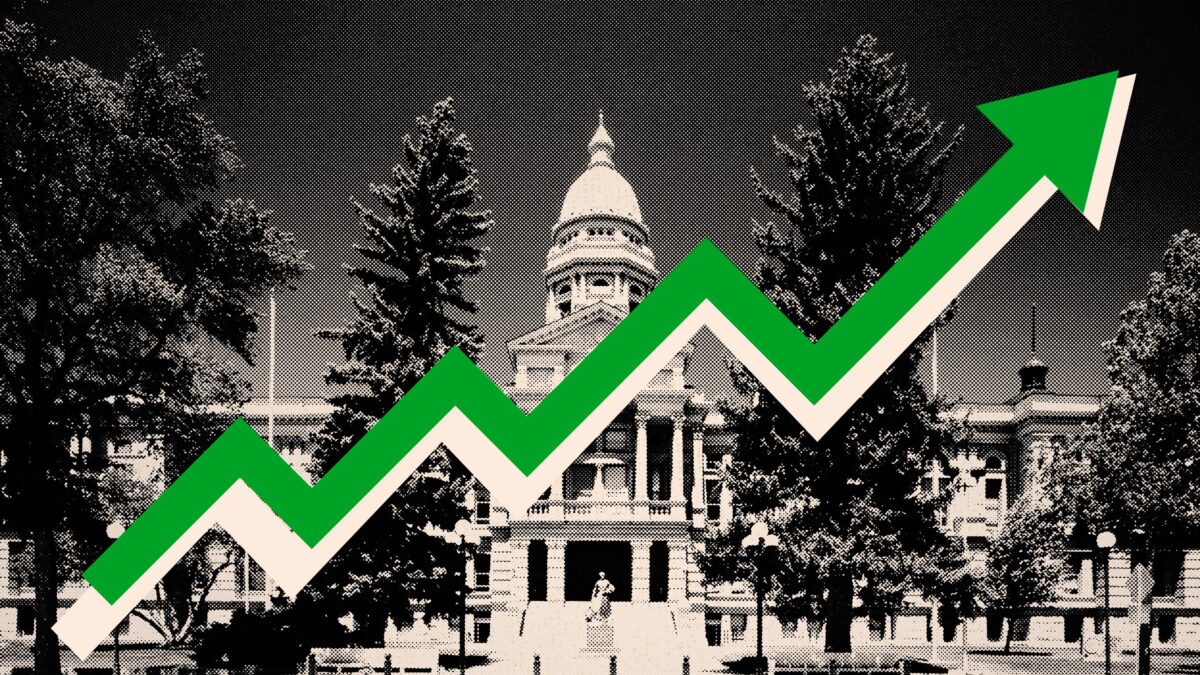 A photo illustration of the Wyoming State Capitol in black and white, with a green arrow pointing up across it.