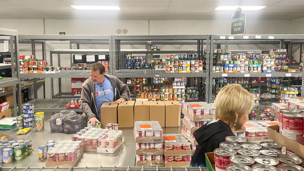 A man sorts through a food delivery at a food bank