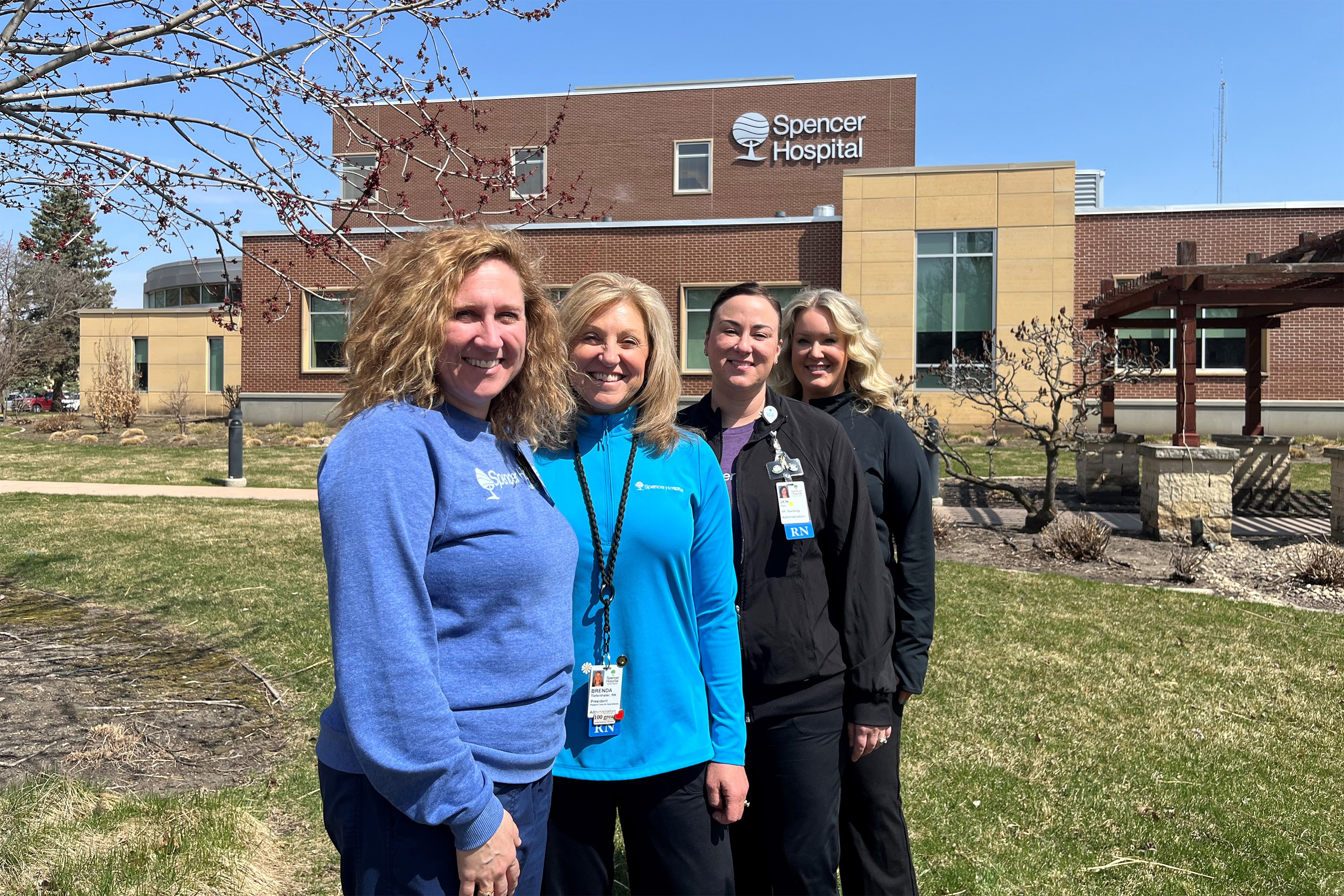 spencerhospital_01-resized A photo of four women standing together for a photo in front of Spencer Hospital.
