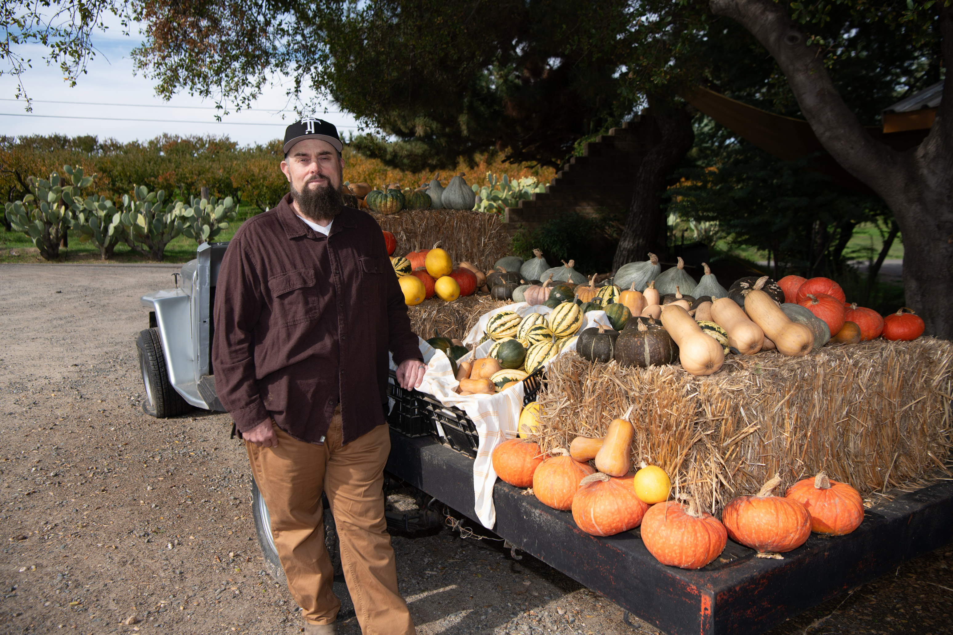 subsidies_miller_22-resize A photo of Justin Miller at his farmers market stand. Pumpkins and squash are seen on the table.