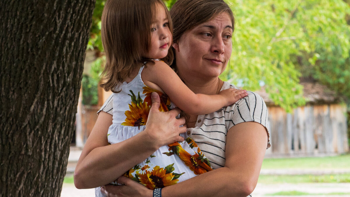 A photo of a Native American mother holding her daughter.