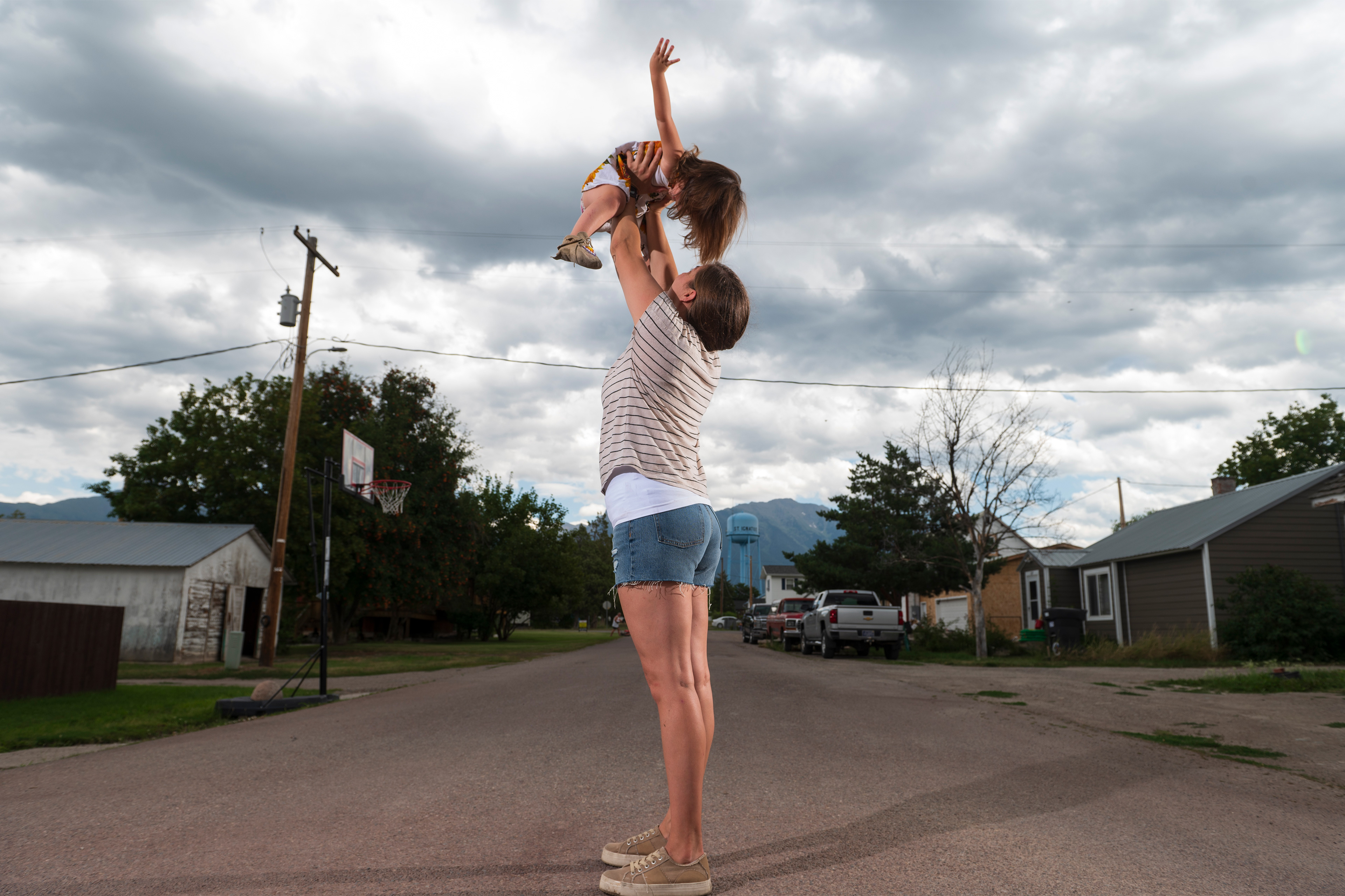 tribesmedicaid_04-resized A photo of Jonnell Wieder holding up her daughter to the sky as they play on their street.