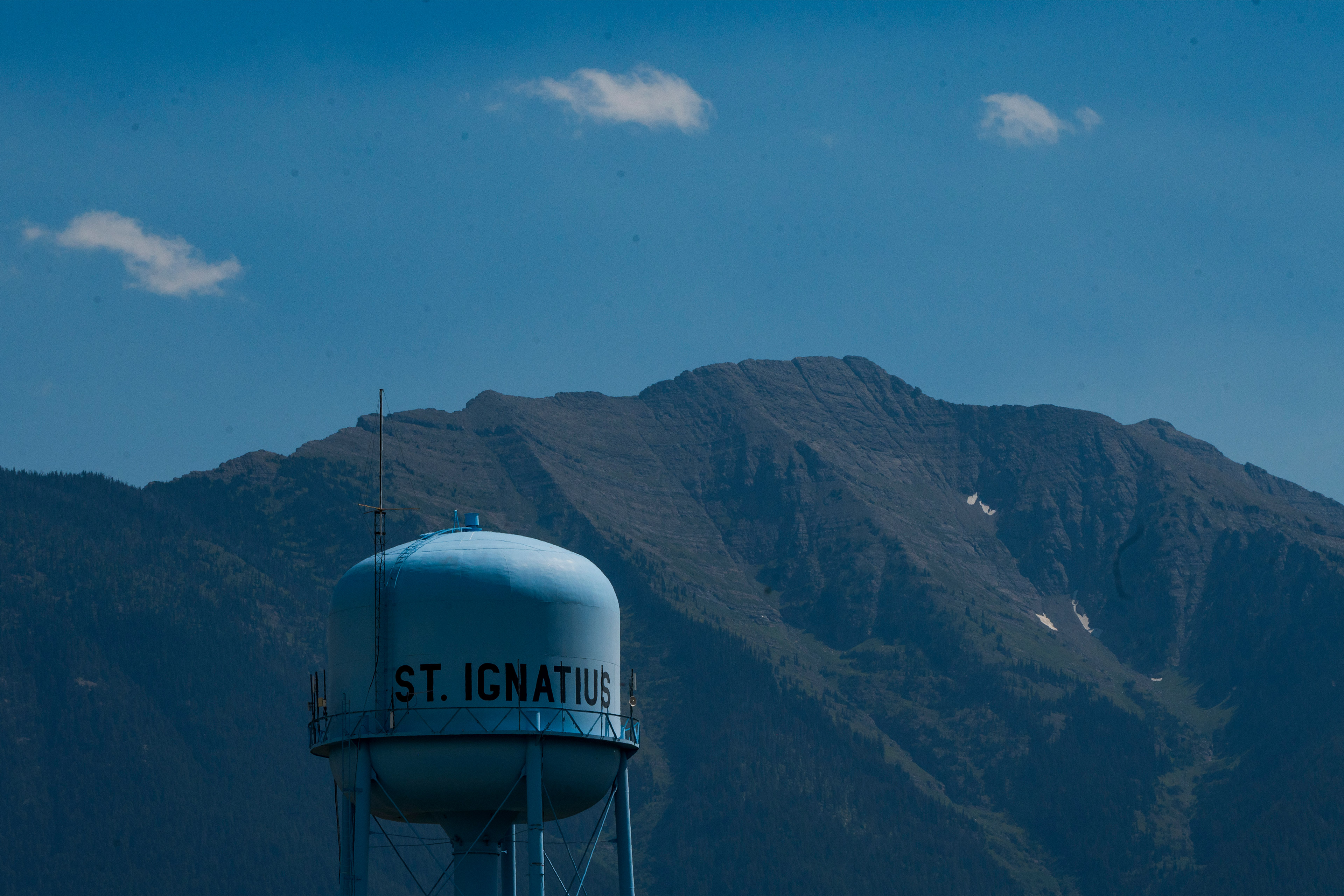 tribesmedicaid_10-resized A photo of a water tower in rural Montana. Mountains are seen behind it.