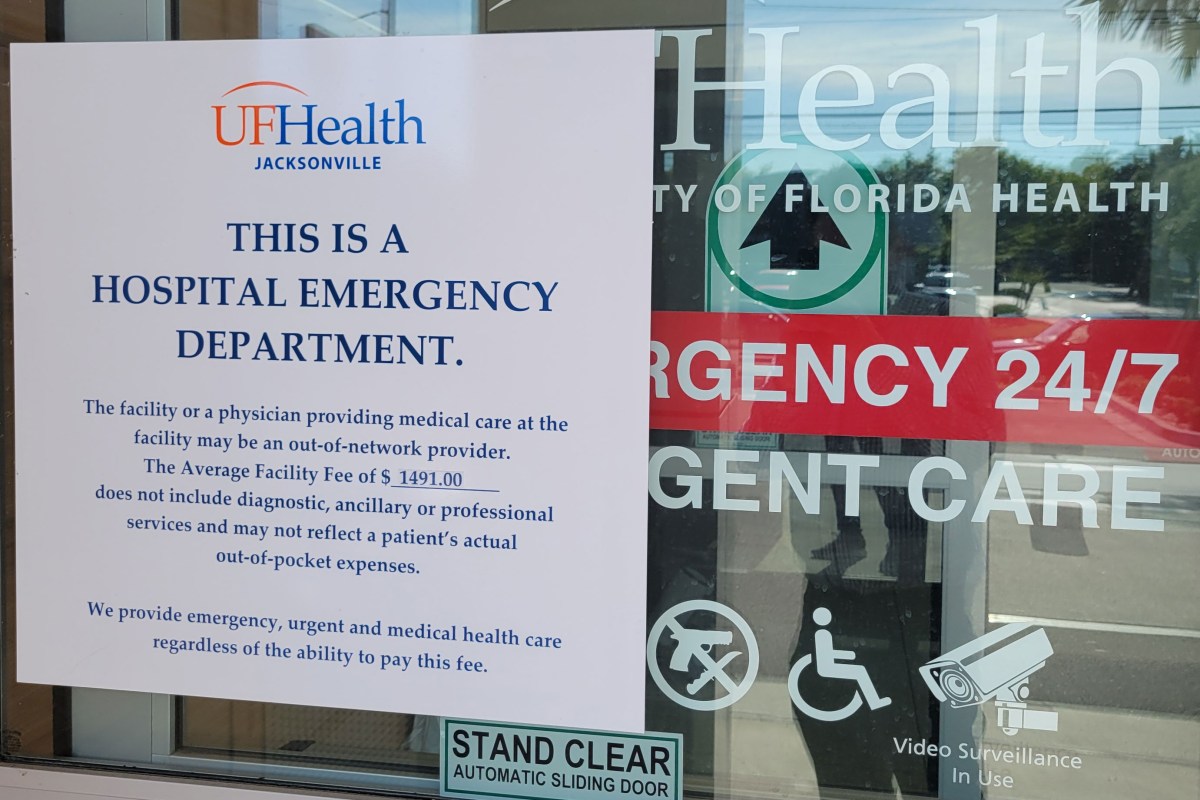 urgenters_02 A paper sign on the front door at a UF Health emergency and urgent care facility notifies patients they may be billed for emergency services.