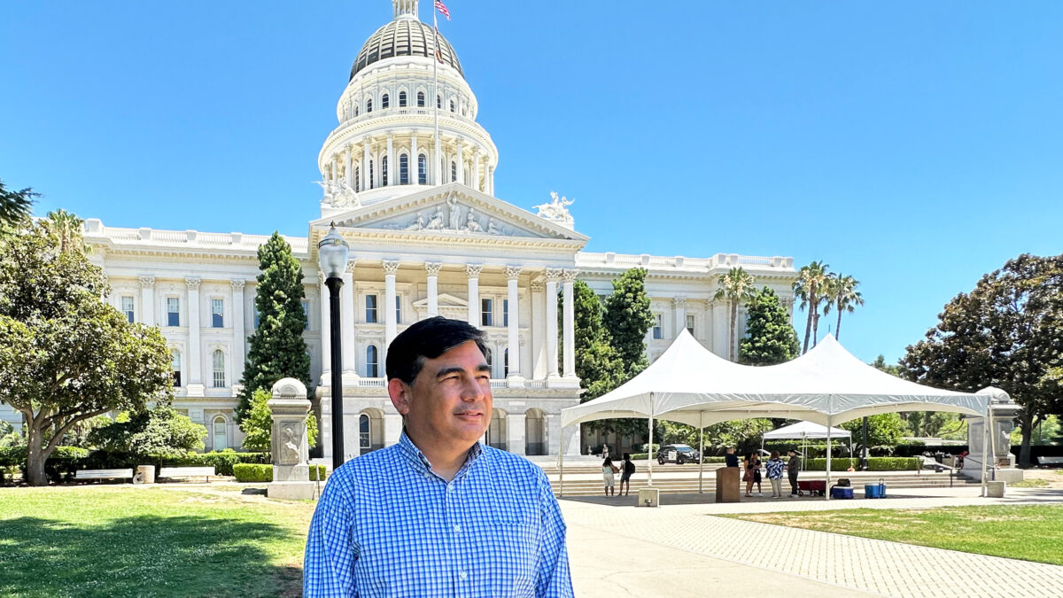 A photo of a man standing outside California's capitol.
